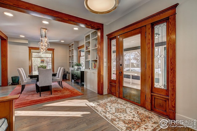 interior space with a chandelier and hardwood / wood-style floors