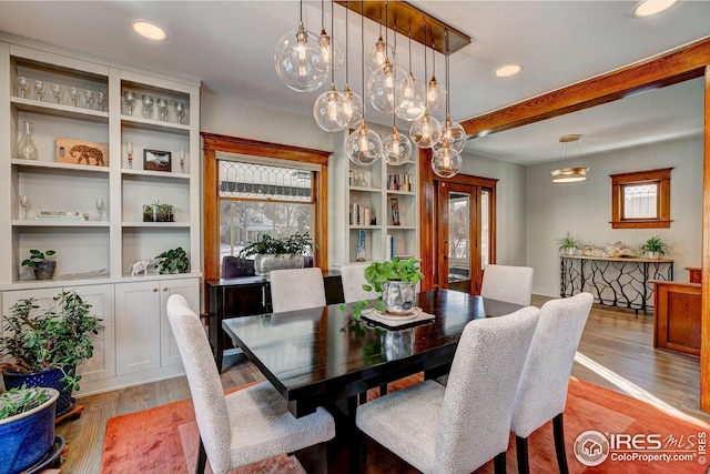 dining room with a healthy amount of sunlight and light hardwood / wood-style floors