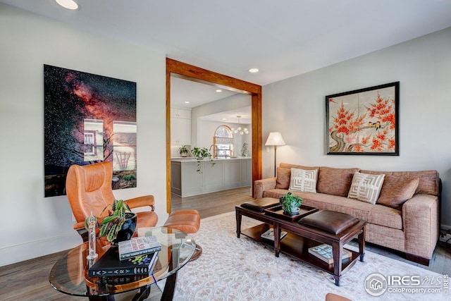 living room featuring hardwood / wood-style floors and an inviting chandelier