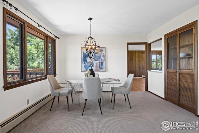 dining space with a baseboard radiator, carpet flooring, a chandelier, and a healthy amount of sunlight