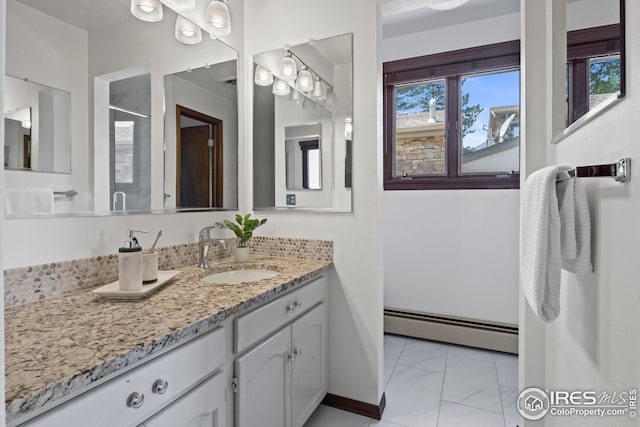 bathroom featuring a shower with shower door, baseboard heating, and vanity