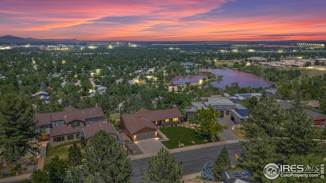 aerial view at dusk with a water view