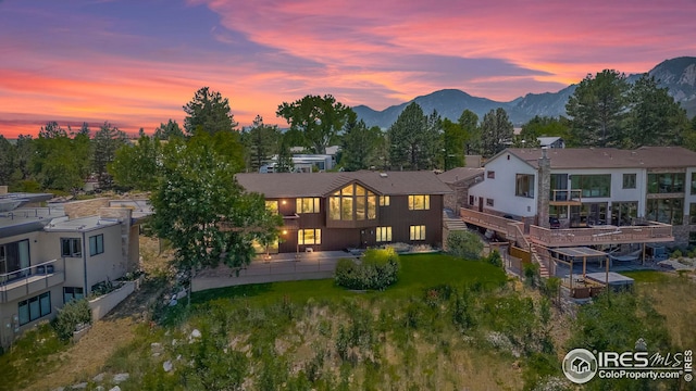 back house at dusk with a mountain view