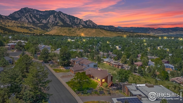 aerial view at dusk featuring a mountain view