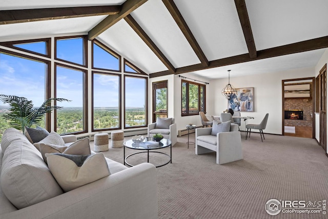 carpeted living room featuring a fireplace, beamed ceiling, high vaulted ceiling, and a notable chandelier