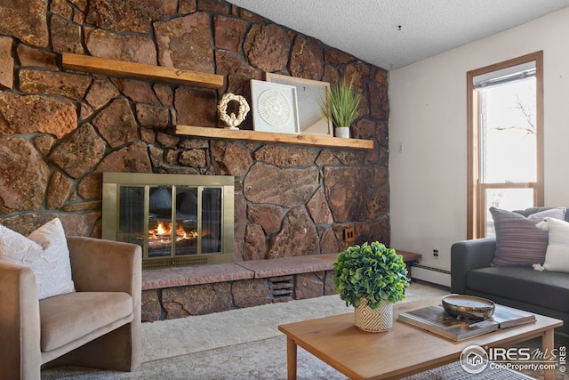 living room with a stone fireplace, baseboard heating, and a textured ceiling