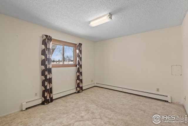 carpeted spare room featuring a textured ceiling and a baseboard heating unit