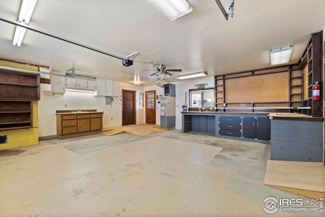garage with sink, a workshop area, and a garage door opener