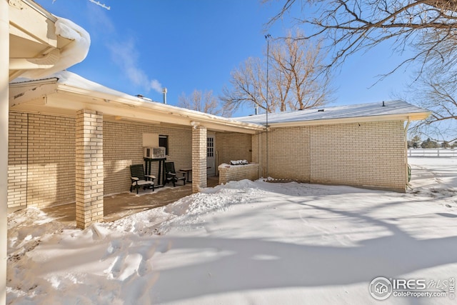 view of snow covered rear of property
