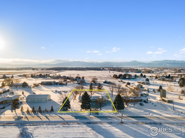 snowy aerial view featuring a mountain view