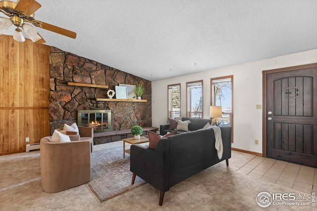 tiled living room featuring a fireplace, wooden walls, lofted ceiling, and a baseboard heating unit