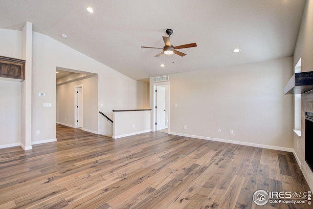 unfurnished living room with visible vents, a ceiling fan, wood finished floors, recessed lighting, and lofted ceiling