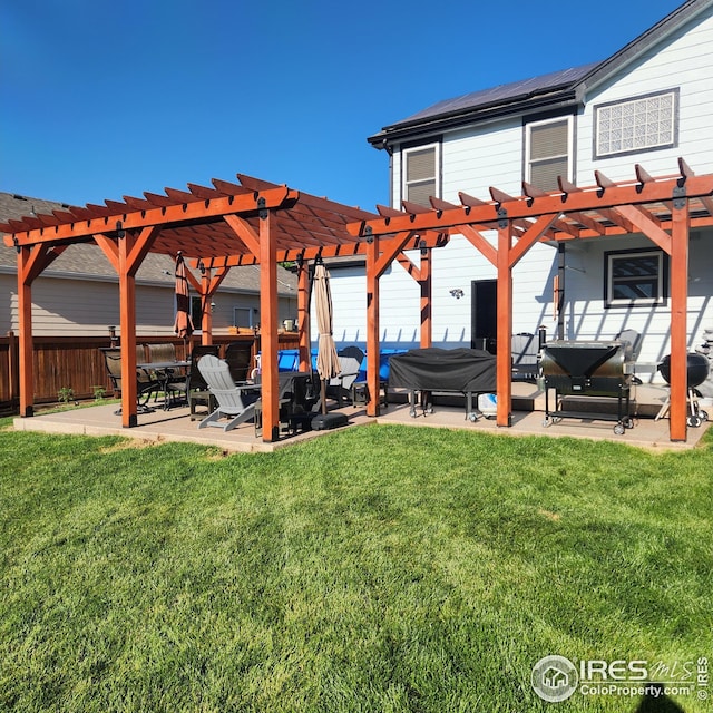 view of yard featuring a patio area, fence, a hot tub, and a pergola