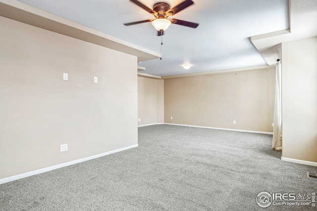 carpeted spare room with ornamental molding and ceiling fan