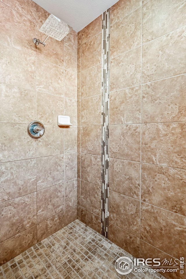 bathroom with tiled shower