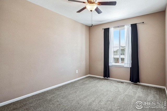 carpeted empty room with a textured ceiling and ceiling fan