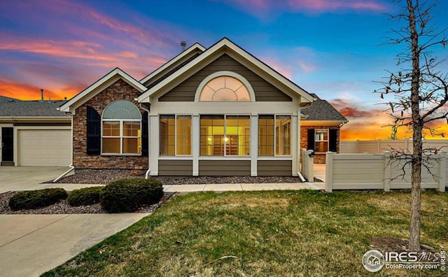 exterior space with a garage and a lawn