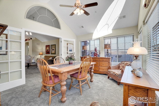 dining area featuring high vaulted ceiling, ceiling fan, and carpet flooring