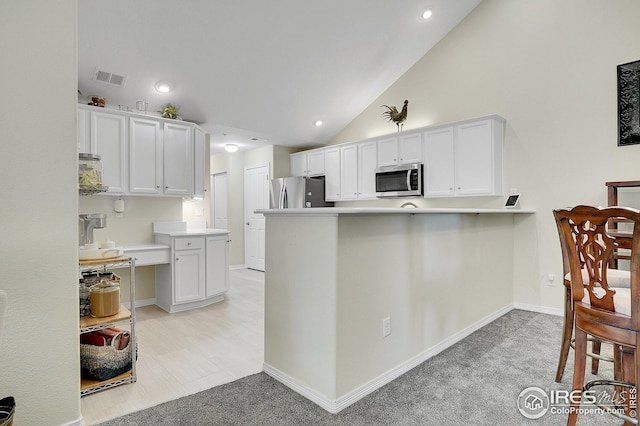 kitchen featuring white cabinetry, high vaulted ceiling, light carpet, kitchen peninsula, and stainless steel appliances