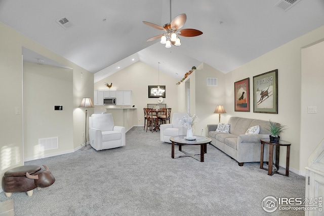 carpeted living room featuring vaulted ceiling and ceiling fan