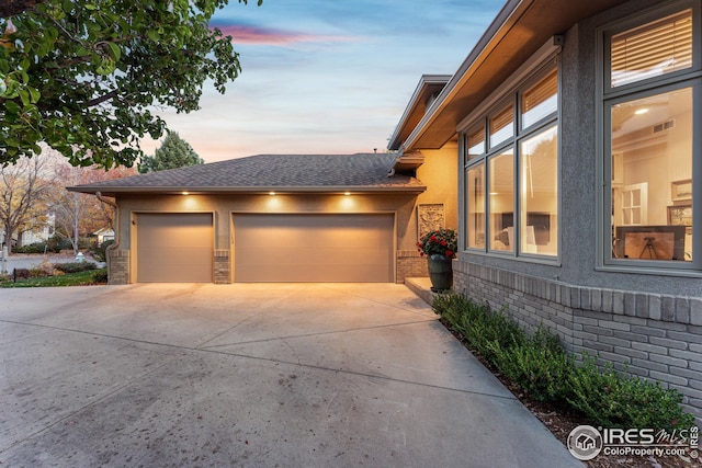 property exterior at dusk featuring a garage