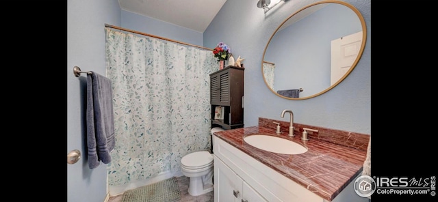 bathroom with vanity, walk in shower, and toilet