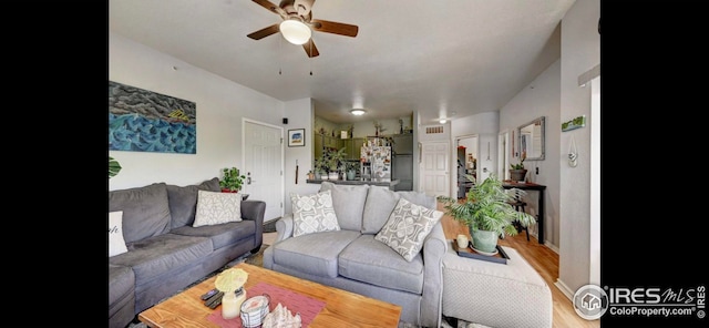 living room with hardwood / wood-style flooring and ceiling fan