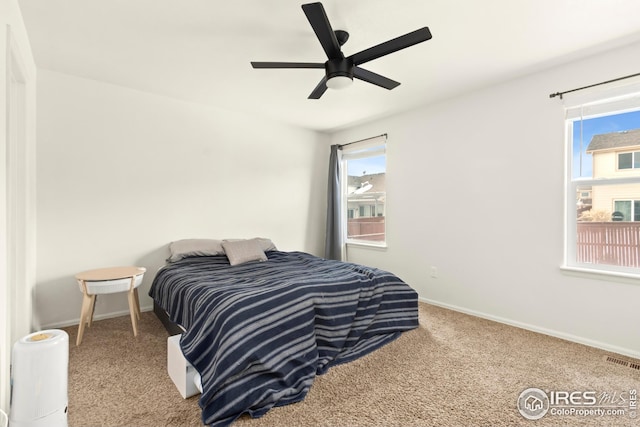 bedroom with multiple windows, carpet floors, and ceiling fan