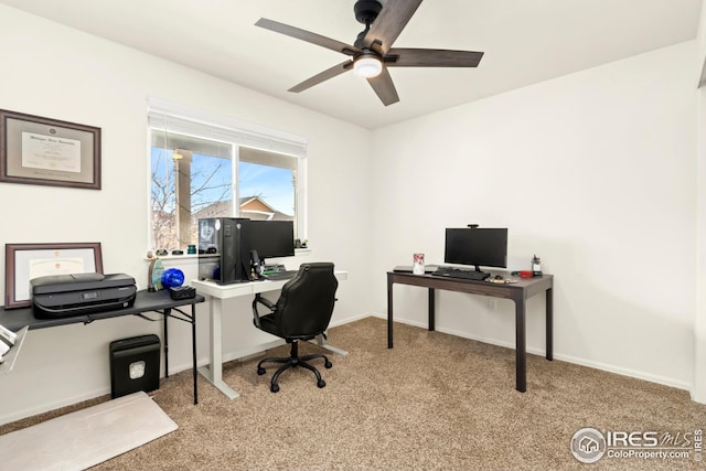 carpeted office space with ceiling fan