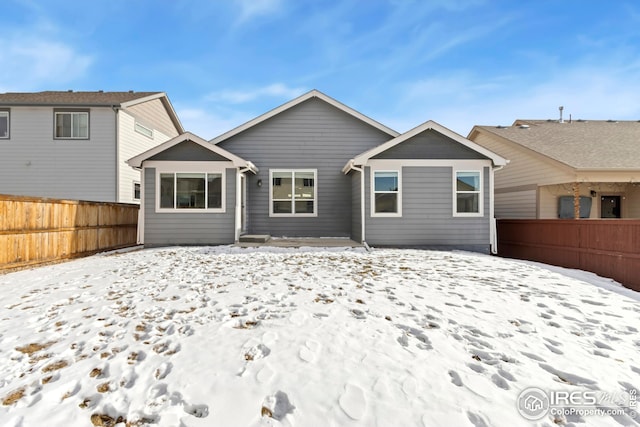 snow covered property featuring electric panel