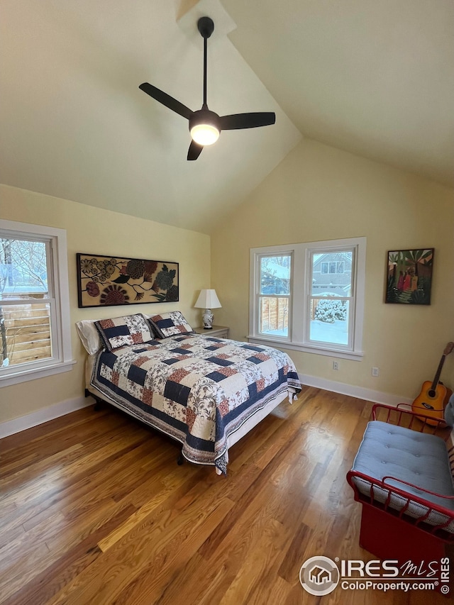 bedroom with vaulted ceiling, hardwood / wood-style floors, and ceiling fan