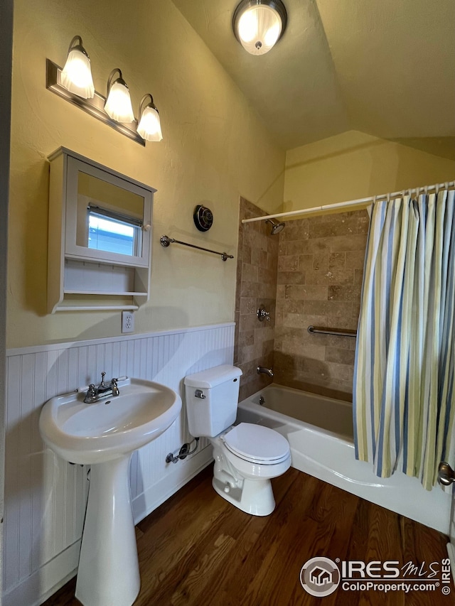 full bathroom featuring hardwood / wood-style floors, lofted ceiling, sink, shower / tub combo, and toilet