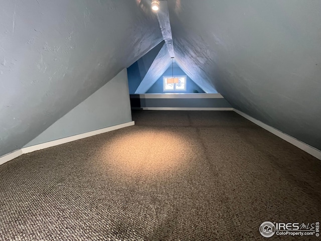 additional living space with vaulted ceiling and carpet