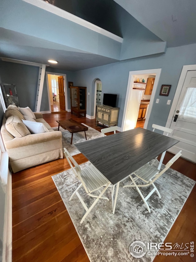 living room with lofted ceiling and dark hardwood / wood-style flooring