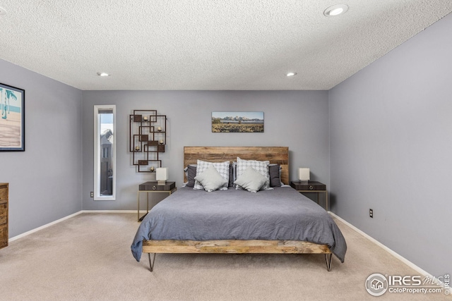 bedroom with carpet and a textured ceiling