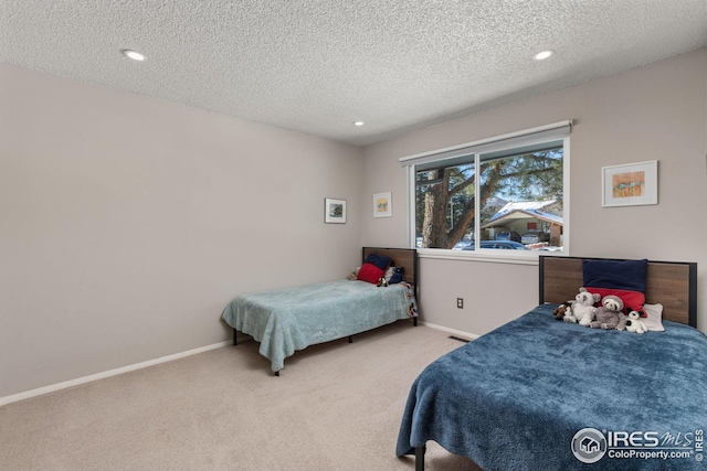 carpeted bedroom with a textured ceiling