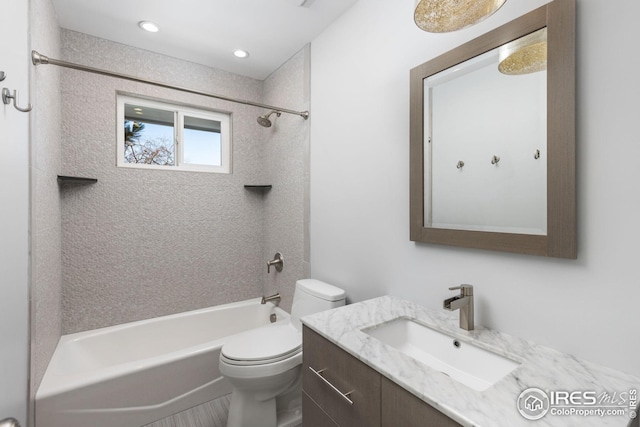 full bathroom featuring vanity, toilet, and tiled shower / bath combo