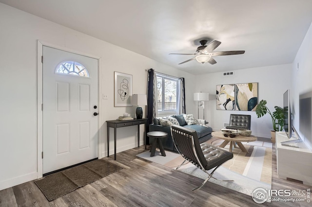 living room featuring hardwood / wood-style flooring and ceiling fan