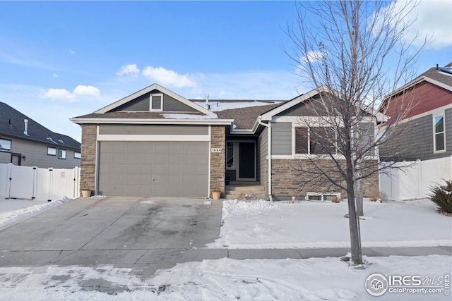 view of front of home with a garage, driveway, and fence