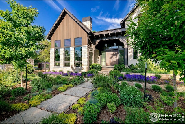 3621 21st St, Boulder, CO 80304 - contemporary house featuring stone siding and a chimney