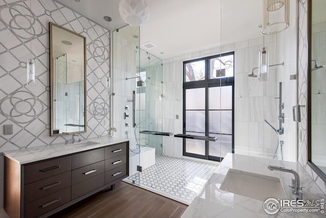 3621 21st St, Boulder, CO 80304 - full bath featuring vanity, tile walls, a shower stall, and wood finished floors