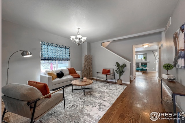 living room with hardwood / wood-style floors and a chandelier