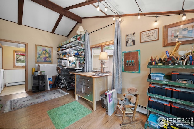 home office featuring a baseboard heating unit, light wood-type flooring, and vaulted ceiling with beams