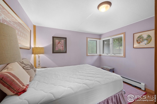 bedroom with a baseboard heating unit
