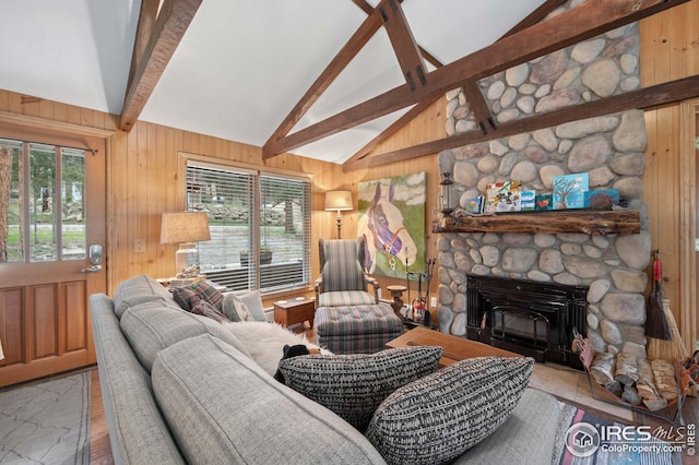 living room with wooden walls, high vaulted ceiling, a fireplace, wood-type flooring, and beamed ceiling