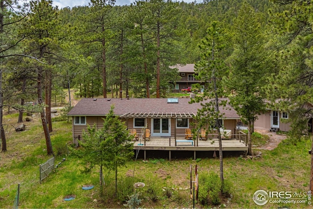 back of house with a wooden deck