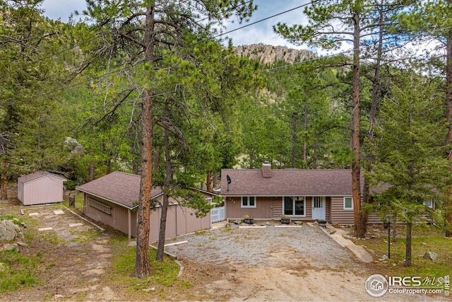 view of front of home featuring a storage unit