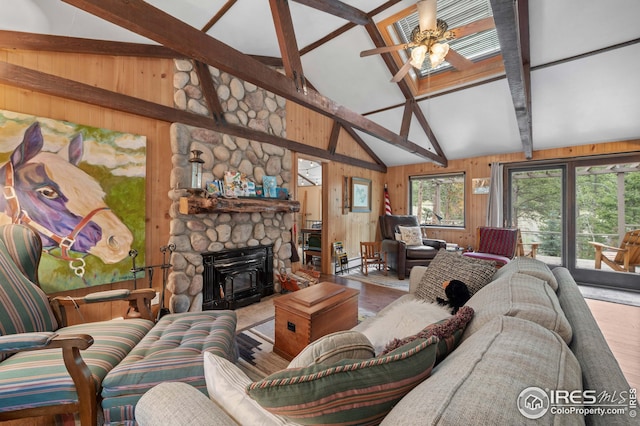 living room with hardwood / wood-style flooring, ceiling fan, beam ceiling, wooden walls, and high vaulted ceiling