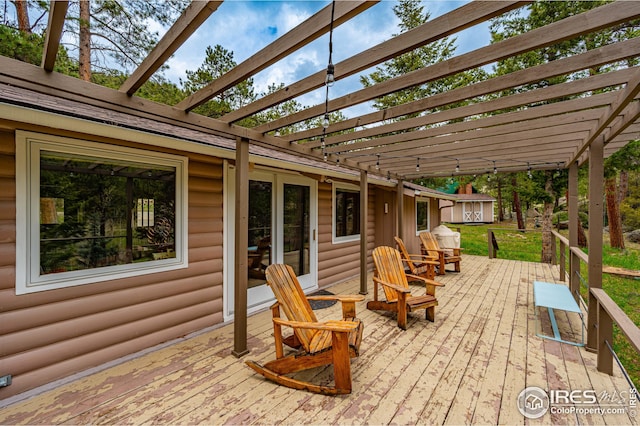 deck featuring a pergola and a shed