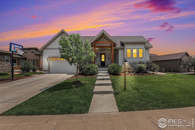 view of front of house with a garage and a lawn